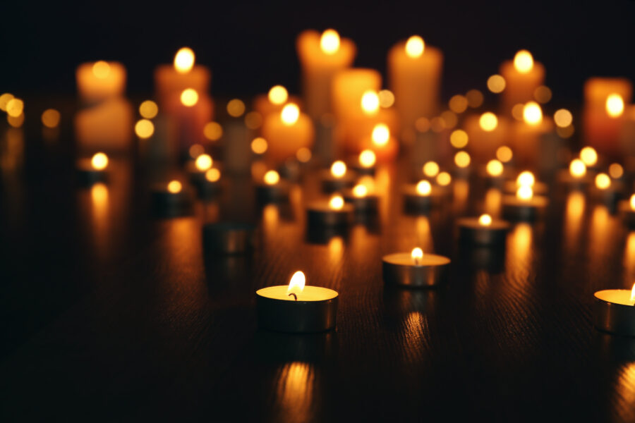 Burning candles on floor in darkness Burning candles on floor in darkness